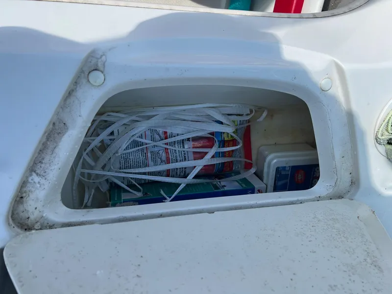 Slide: The Image of Storage compartment on a 2006 Sea Ray 205 Sport boat with safety equipment. - 12