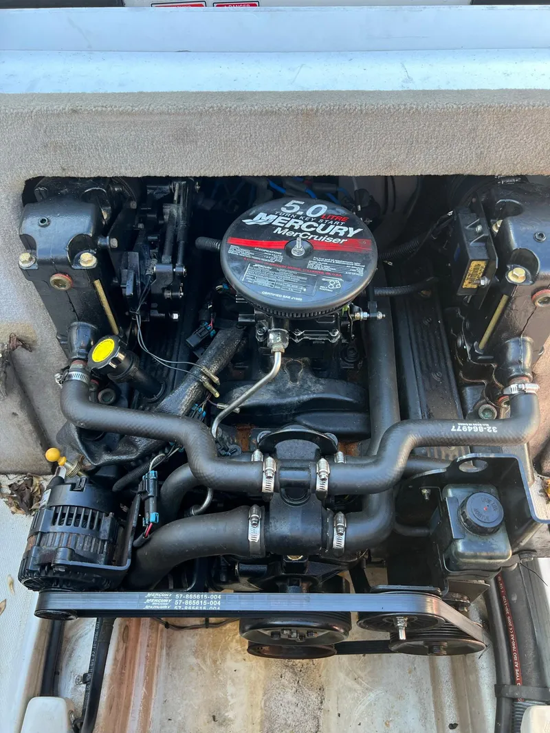 Slide: The Image of Engine of a 2006 Sea Ray 205 Sport boat, featuring a 5.0L Mercury motor. - 14