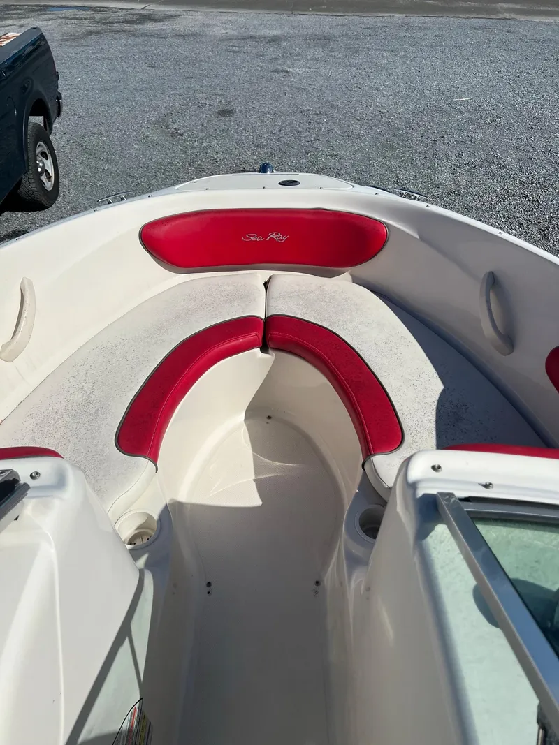 Slide: The Image of 2006 Sea Ray 205 Sport boat with red and white seating in the bow area. - 5
