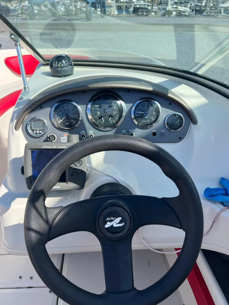 Slide: The Image of Dashboard of a 2006 Sea Ray 205 Sport boat with steering wheel and gauges. - 8
