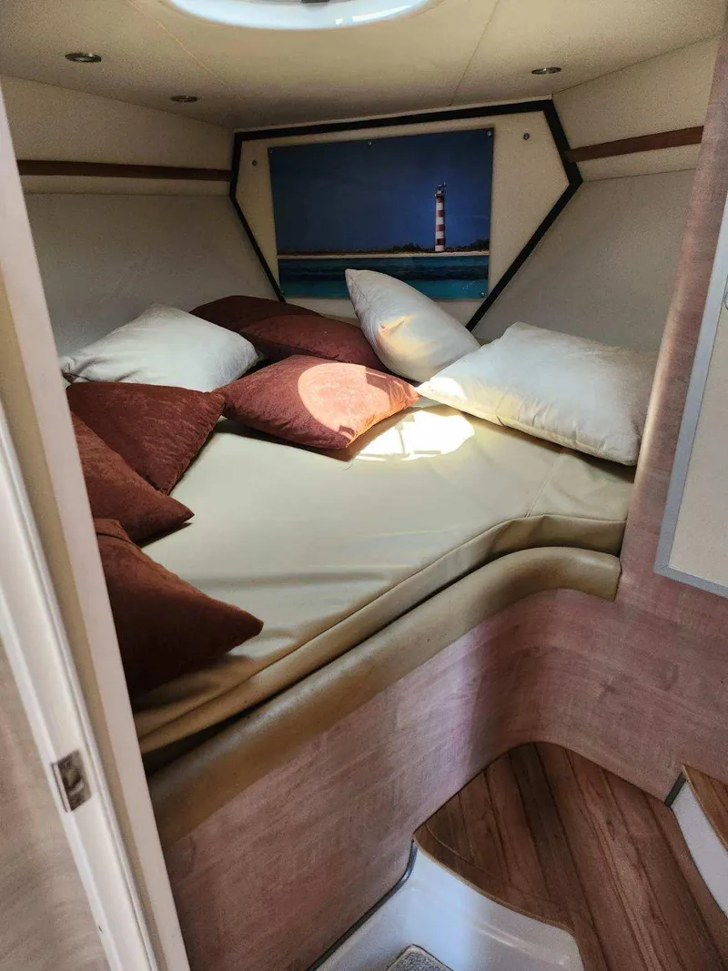 Slide: The Image of Cozy cabin interior of 2018 Pronautica 1260 Super Sport with bed and pillows. - 12