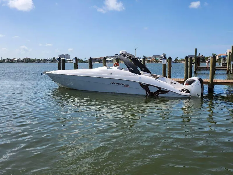 Slide: The Image of 2018 Pronautica 1260 Super Sport boat docked on calm water. - 22