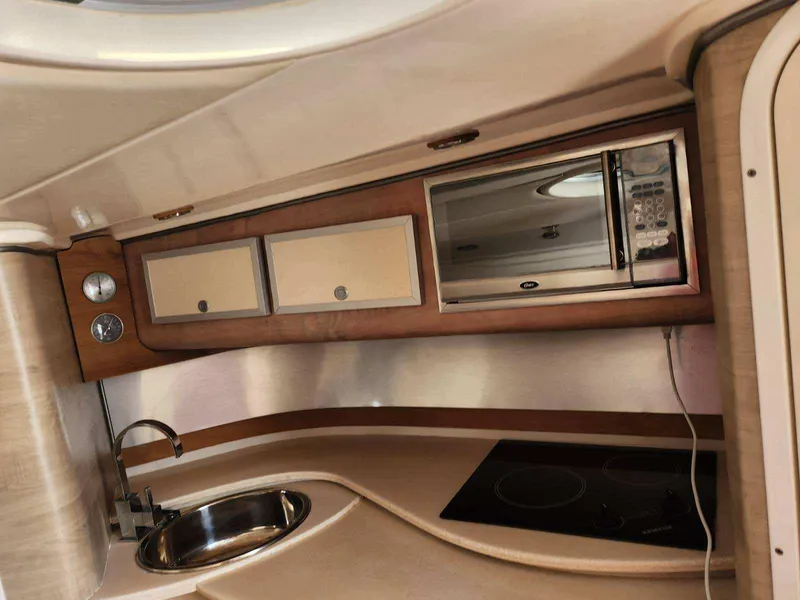 Slide: The Image of 2018 Pronautica 1260 Super Sport boat interior kitchen with microwave, sink, and stove. - 8
