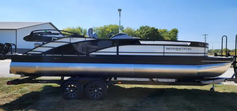 Slide: The Image of 2024 Bennington 25 RTSB pontoon boat on a trailer, side view. - 0