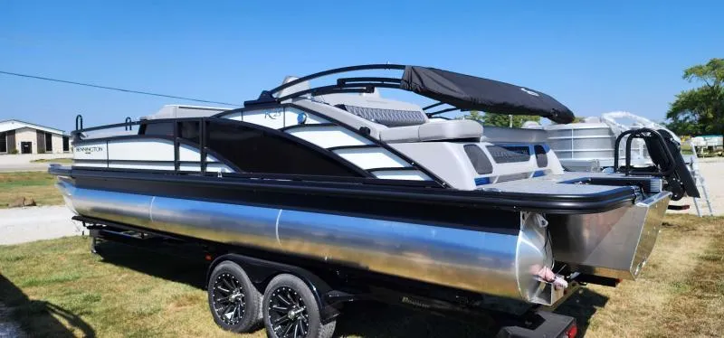 Slide: The Image of 2024 Bennington 25 RTSB pontoon boat on a trailer, side view. - 2