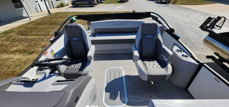 Slide: The Image of 2024 Bennington 25 RTSB boat interior with gray seating and steering console. - 5