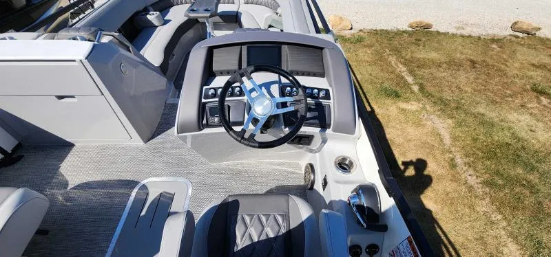 Slide: The Image of 2024 Bennington 25 RTSB boat interior with modern steering console and seating. - 6