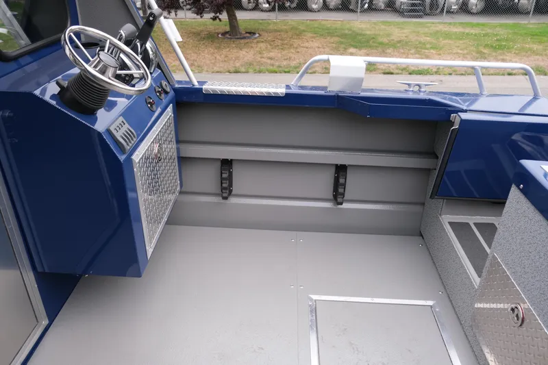 Slide: The Image of 2024 Thunder Jet 21 Chinook Pro boat interior with steering wheel and storage compartments. - 11