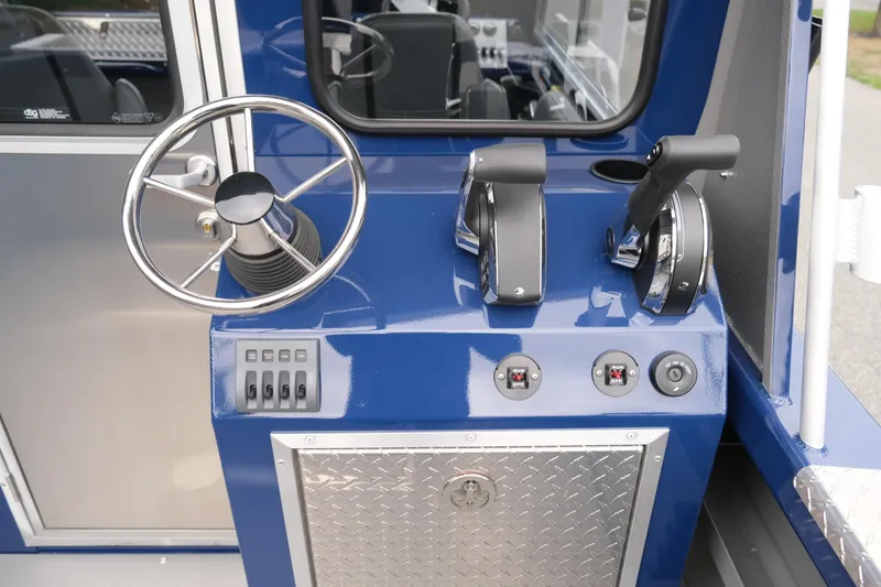 Slide: The Image of 2024 Thunder Jet 21 Chinook Pro boat helm with steering wheel and controls. - 12