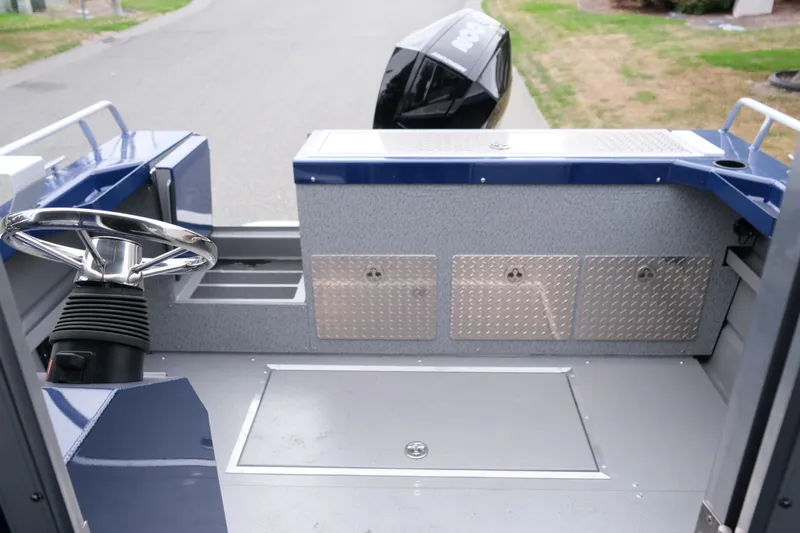 Slide: The Image of 2024 Thunder Jet 21 Chinook Pro boat interior with steering wheel and storage compartments. - 13