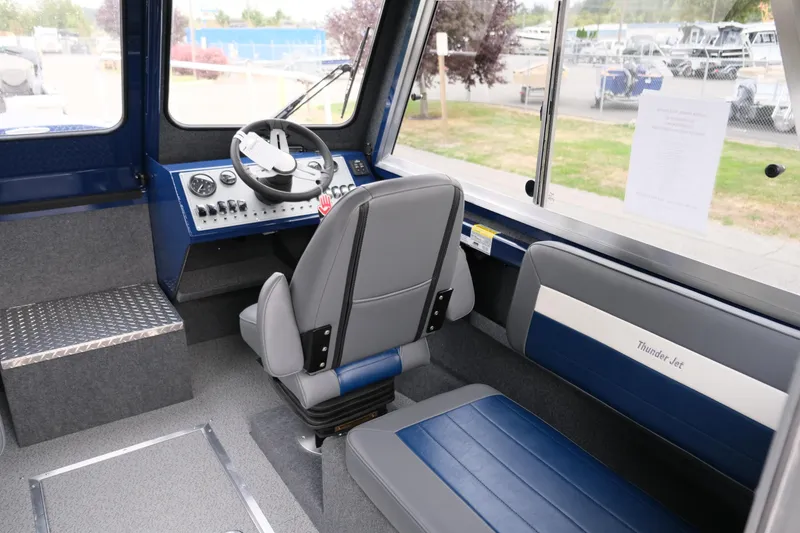 Slide: The Image of Interior of 2024 Thunder Jet 21 Chinook Pro boat, featuring helm and seating area. - 15