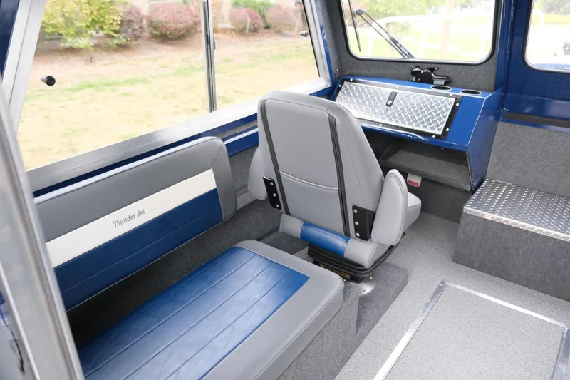 Slide: The Image of Interior of 2024 Thunder Jet 21 Chinook Pro boat with blue and gray seating. - 18