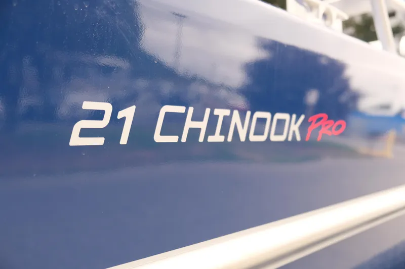 Slide: The Image of 2024 Thunder Jet 21 Chinook Pro boat model name on blue exterior. - 8