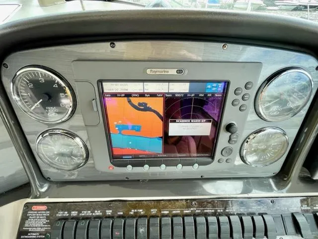 Slide: The Image of Dashboard of a 2007 Sea Ray 38 Sundancer with navigation display and gauges. - 12