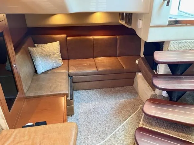 Slide: The Image of Luxurious interior of 2007 Sea Ray 38 Sundancer with leather seating and wooden stairs. - 13