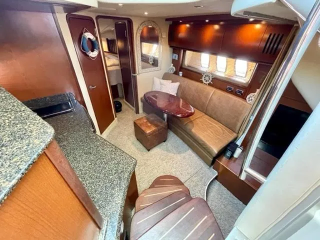 Slide: The Image of Interior of 2007 Sea Ray 38 Sundancer yacht with cozy seating and elegant wood finishes. - 15