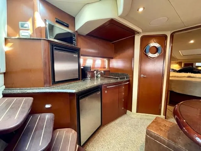Slide: The Image of Interior of 2007 Sea Ray 38 Sundancer yacht with kitchen and cozy cabin. - 18