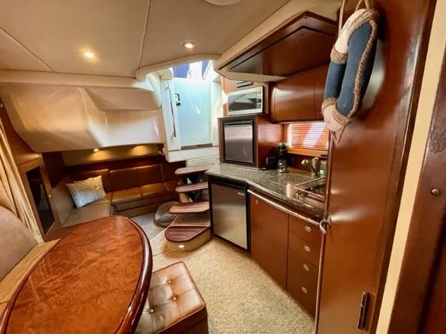 Slide: The Image of Interior of 2007 Sea Ray 38 Sundancer yacht with kitchen and seating area. - 19