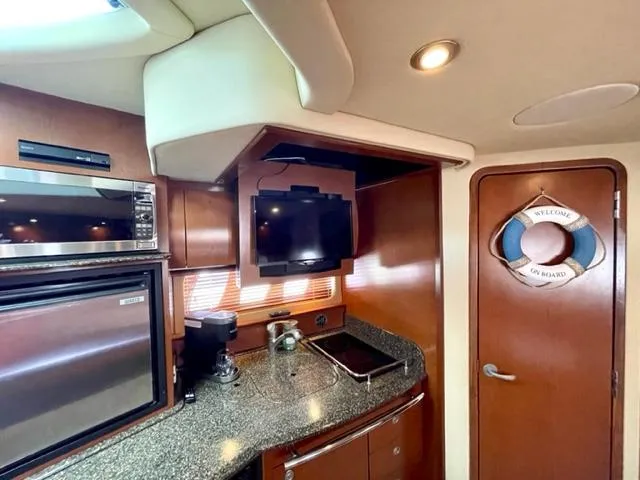 Slide: The Image of Interior of 2007 Sea Ray 38 Sundancer yacht with kitchen and welcome sign on door. - 20