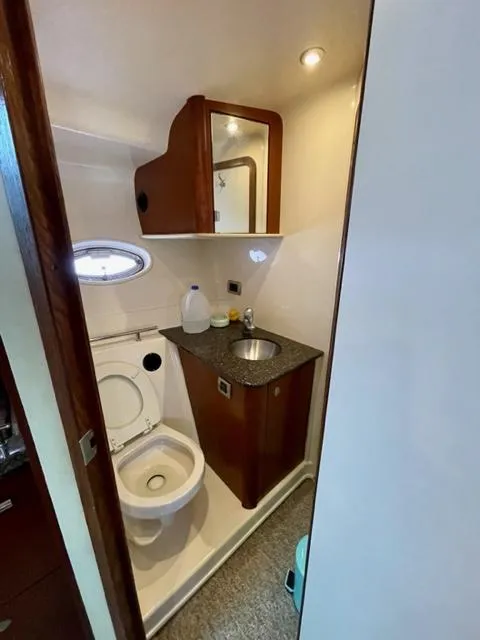 Slide: The Image of 2007 Sea Ray 38 Sundancer bathroom with sink, toilet, and mirror. - 21