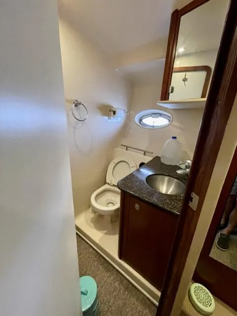 Slide: The Image of 2007 Sea Ray 38 Sundancer bathroom with sink, toilet, and porthole window. - 22