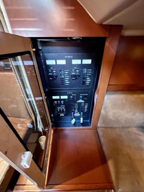 Slide: The Image of Electrical panel inside 2007 Sea Ray 38 Sundancer yacht, featuring control switches and indicators. - 24