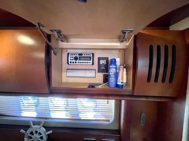 Slide: The Image of 2007 Sea Ray 38 Sundancer interior cabinet with stereo system and sunscreen. - 25