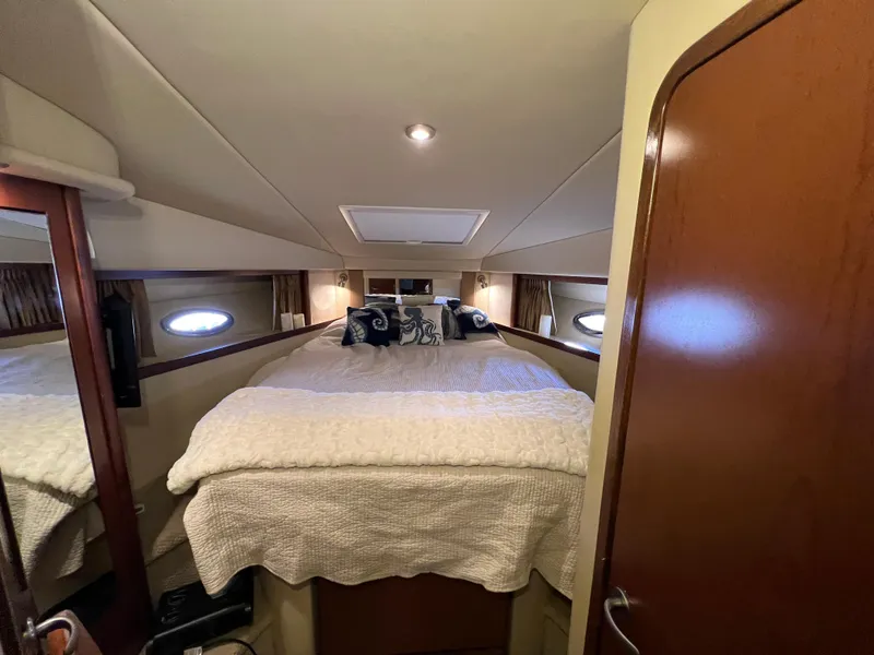 Slide: The Image of 2007 Sea Ray 38 Sundancer cabin interior with cozy bed and elegant decor. - 26
