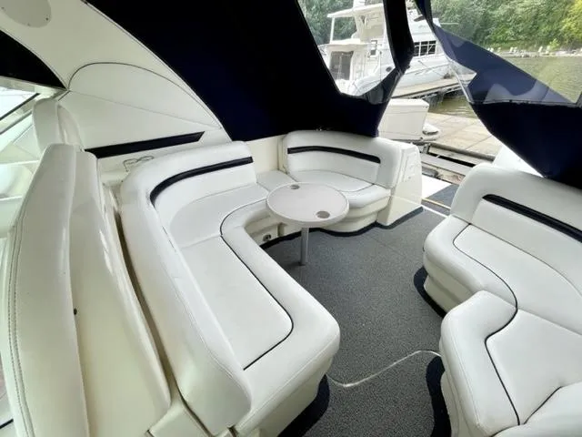 Slide: The Image of Luxurious 2007 Sea Ray 38 Sundancer yacht interior with white seating and table. - 3