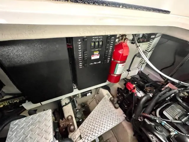 Slide: The Image of Engine compartment of a 2007 Sea Ray 38 Sundancer with fire extinguisher and control panel. - 30