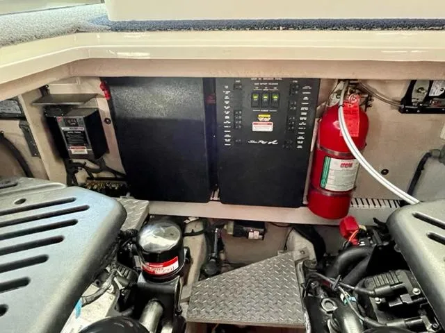 Slide: The Image of Engine compartment of a 2007 Sea Ray 38 Sundancer with control panels and fire extinguisher. - 33