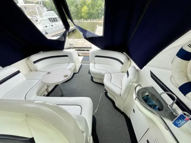 Slide: The Image of 2007 Sea Ray 38 Sundancer interior with white seating, table, and sink. - 4