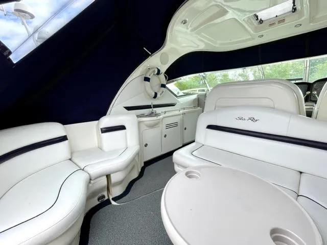 Slide: The Image of Luxurious interior of 2007 Sea Ray 38 Sundancer yacht with white seating and table. - 5