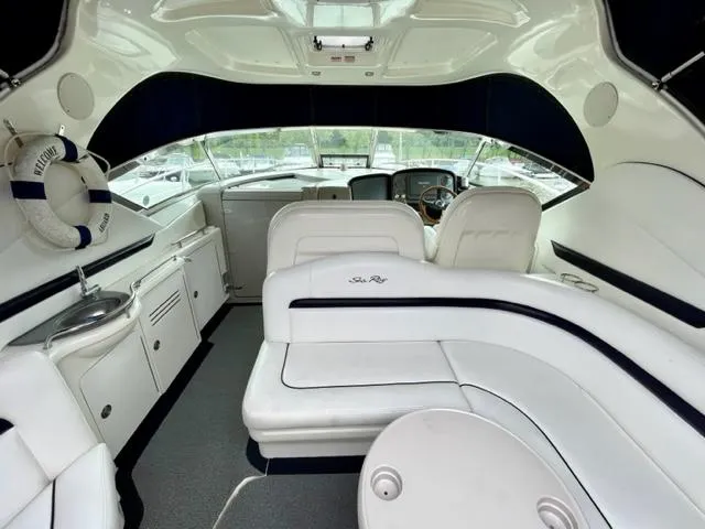 Slide: The Image of 2007 Sea Ray 38 Sundancer interior with white seating and helm. - 6