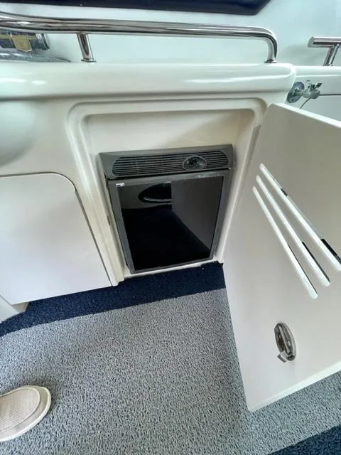 Slide: The Image of 2007 Sea Ray 38 Sundancer interior cabinet with open door and storage space. - 7