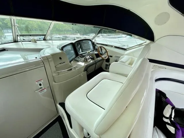 Slide: The Image of 2007 Sea Ray 38 Sundancer helm with white seating and modern controls. - 8