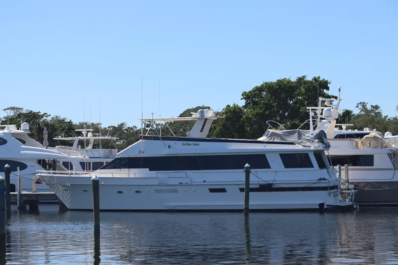 Slide: The Image of 1991 Viking Motor Yacht docked at a marina on a sunny day. - 0