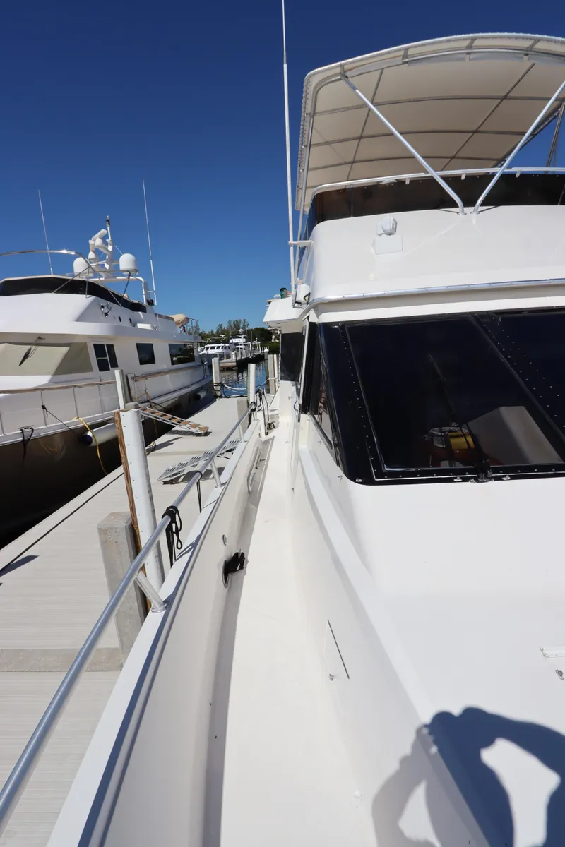 Slide: The Image of 1991 Viking Motor Yacht docked at a marina on a sunny day. - 10