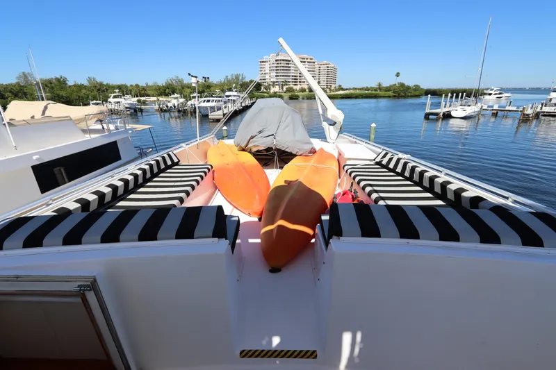 Slide: The Image of 1991 Viking Motor Yacht with kayaks on deck, docked at a marina. - 12