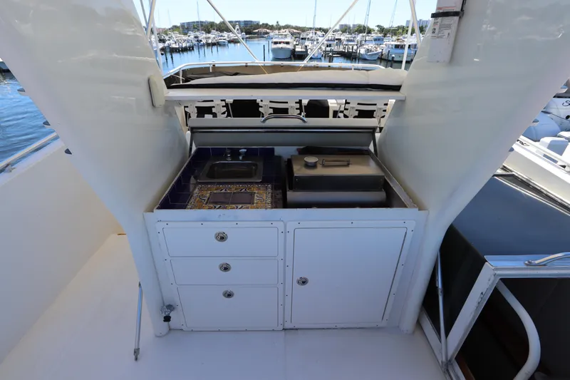 Slide: The Image of 1991 Viking Motor Yacht outdoor kitchen with sink and grill at marina. - 15