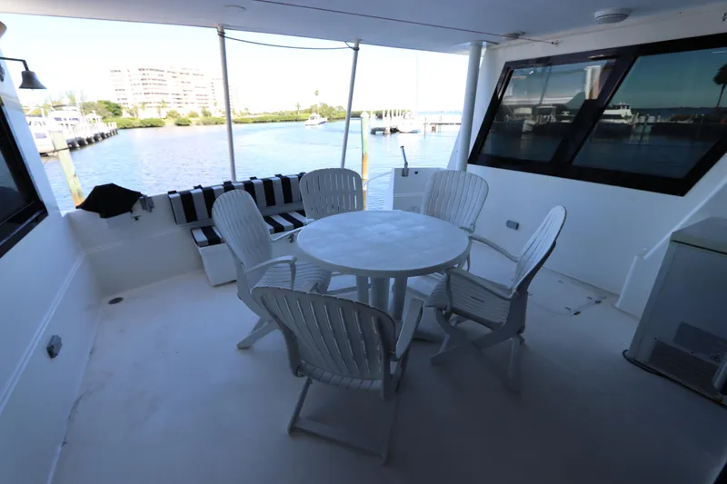 Slide: The Image of 1991 Viking Motor Yacht deck with seating area and waterfront view. - 18