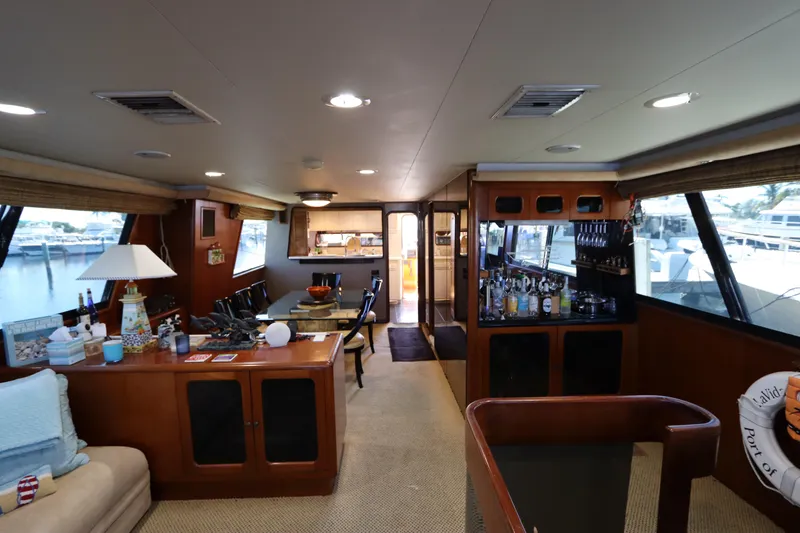 Slide: The Image of Interior of a 1991 Viking Motor Yacht with a cozy living area and bar. - 22