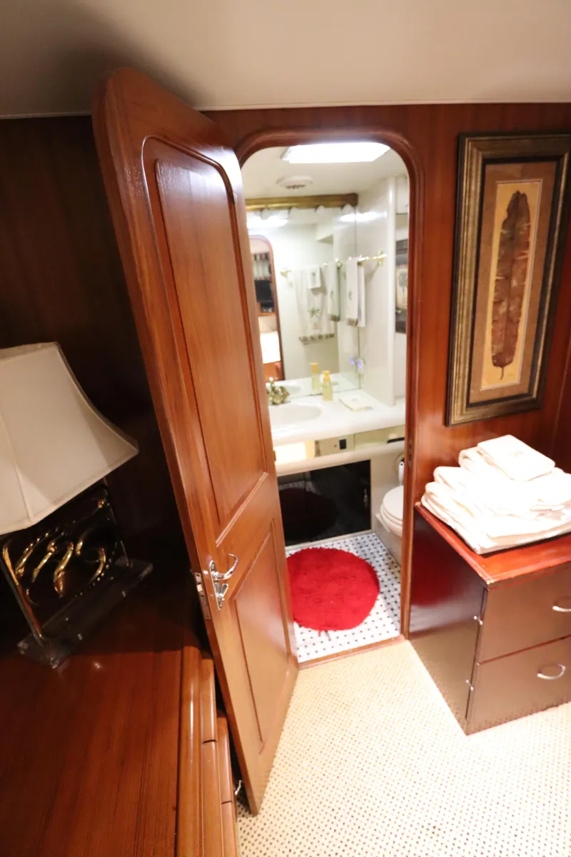 Slide: The Image of Interior of 1991 Viking Motor Yacht with view of bathroom through wooden door. - 25