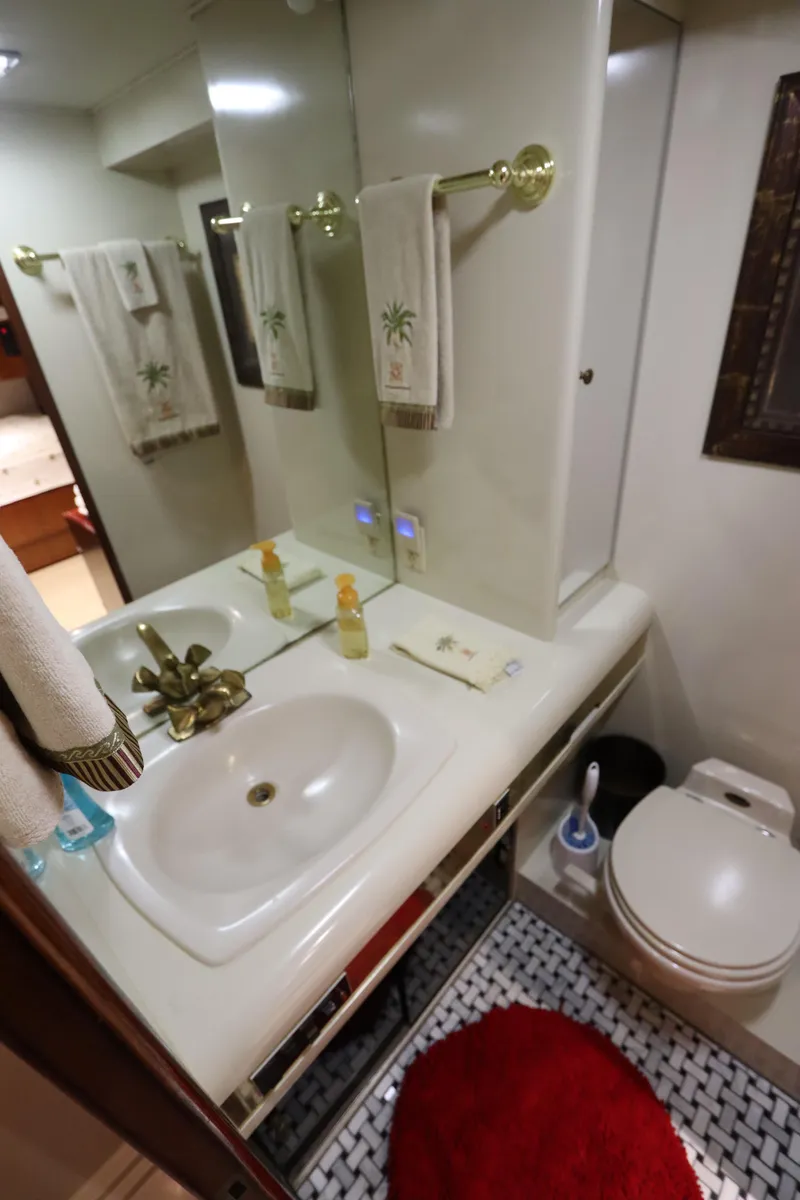 Slide: The Image of 1991 Viking Motor Yacht bathroom with sink, mirror, and toilet. - 26