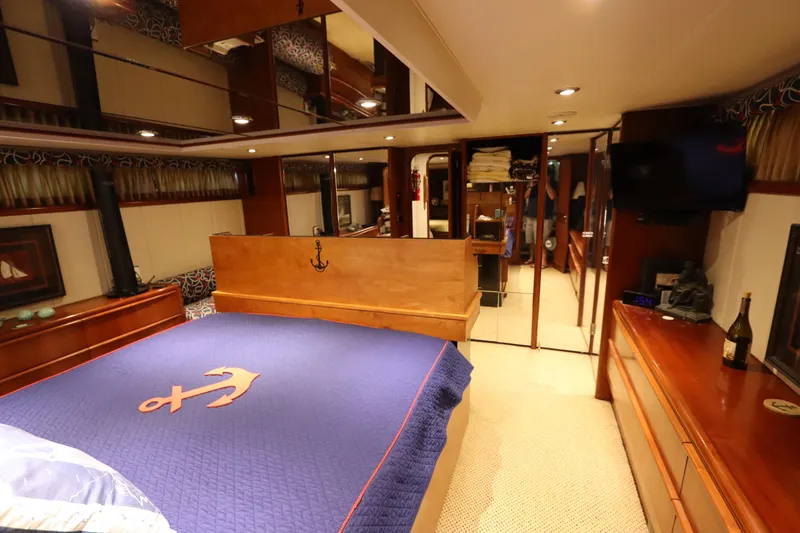 Slide: The Image of Luxurious bedroom in a 1991 Viking Motor Yacht with anchor-themed bedding. - 29