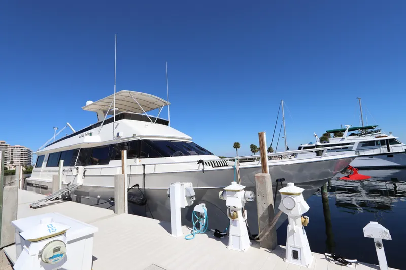 Slide: The Image of 1991 Viking Motor Yacht docked at a marina under a clear blue sky. - 3