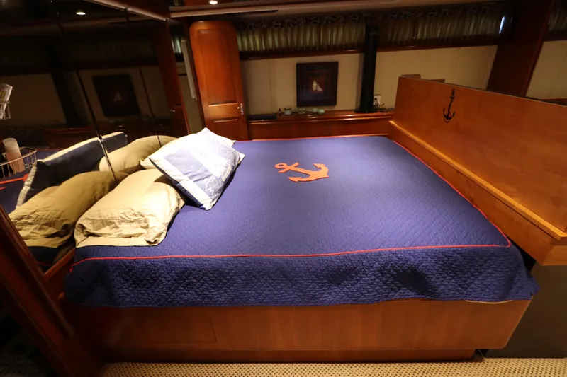 Slide: The Image of Luxurious bedroom in a 1991 Viking Motor Yacht with nautical-themed bedding. - 30