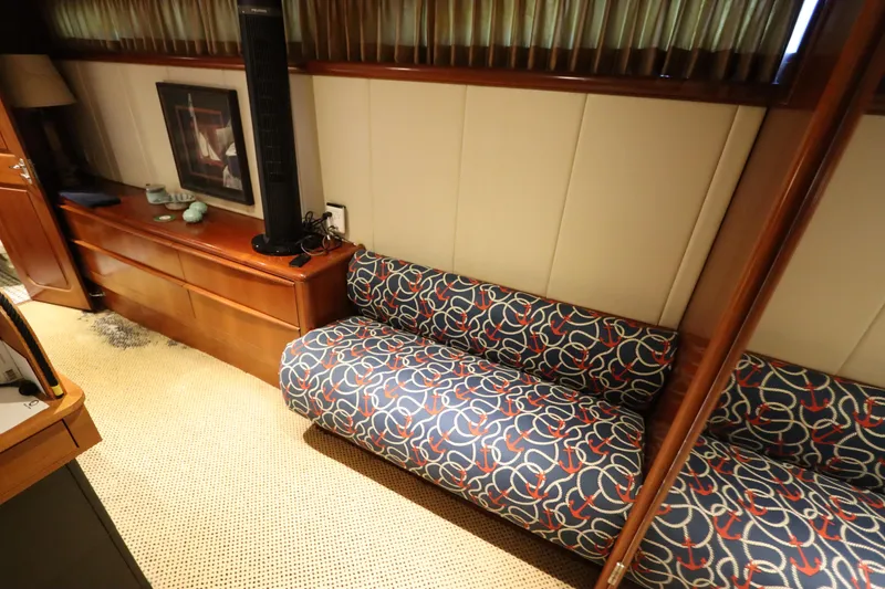 Slide: The Image of Interior of 1991 Viking Motor Yacht with patterned sofa and wooden cabinetry. - 31