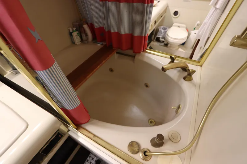 Slide: The Image of 1991 Viking Motor Yacht bathroom with bathtub, shower, and toilet. - 34