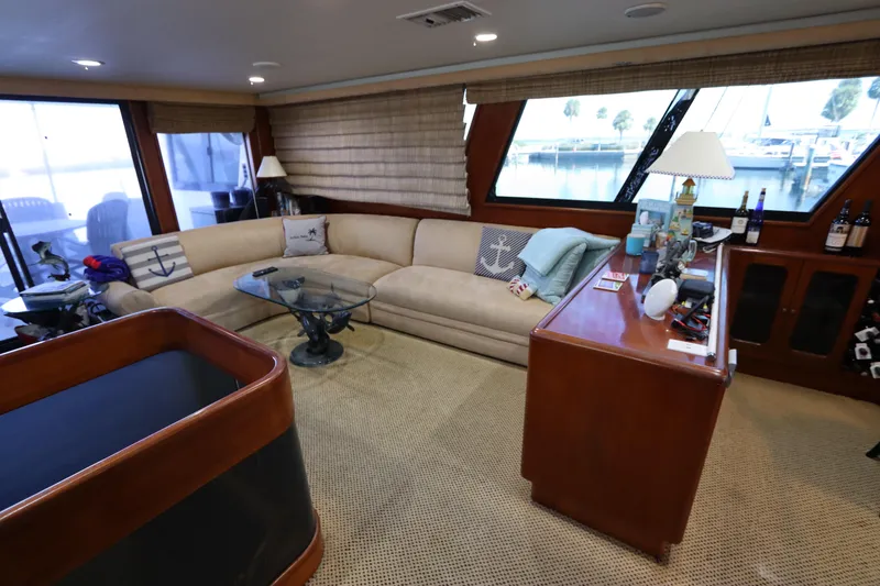 Slide: The Image of Luxurious interior of a 1991 Viking Motor Yacht with beige sofa and wooden cabinetry. - 36